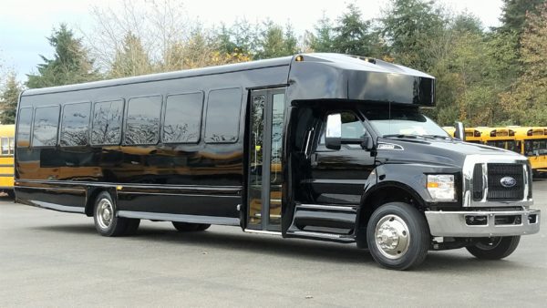 Large black bus on pavement