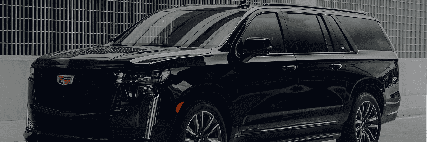 Sleek black SUV near modern building