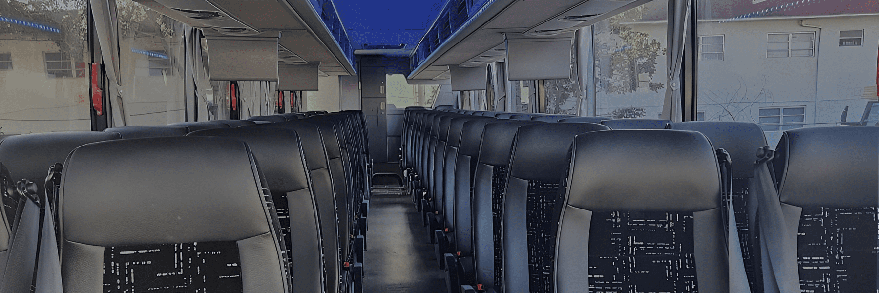 Empty bus interior with rows of seats.