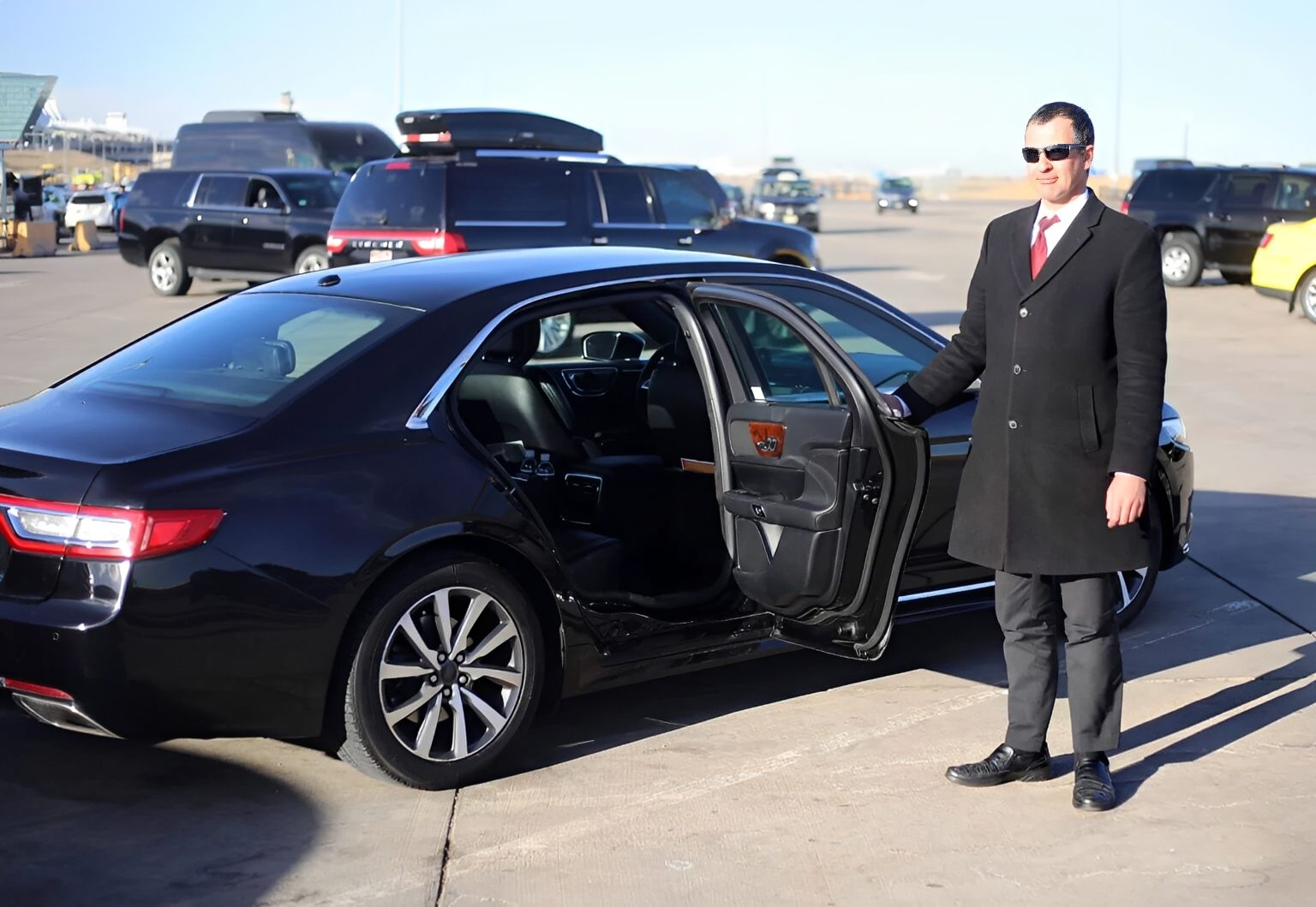 Man in suit beside open car door