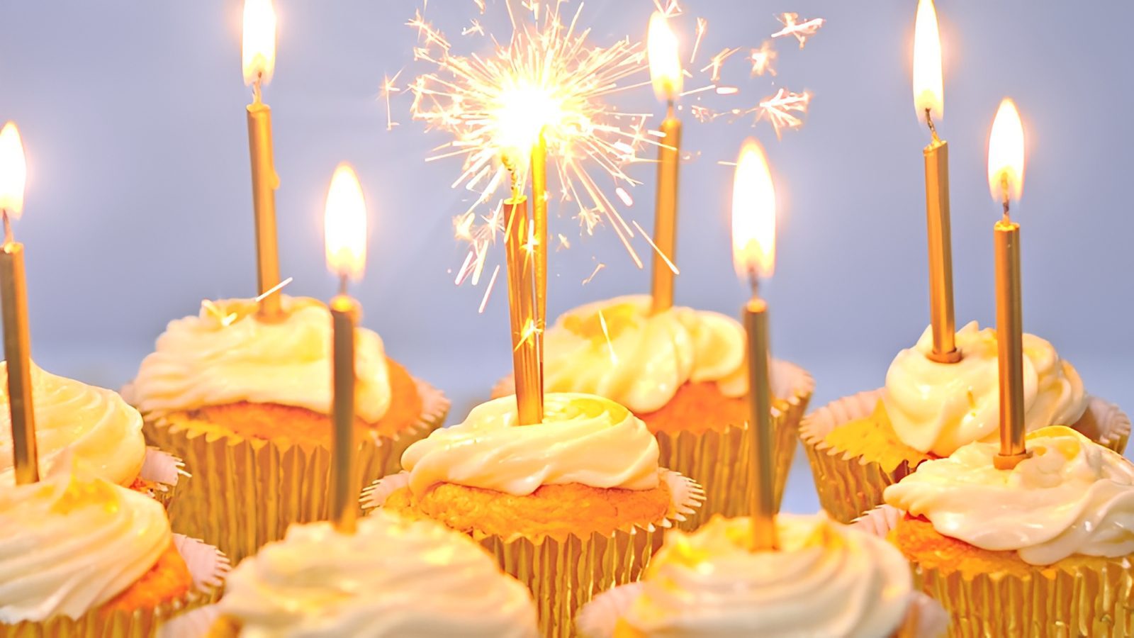 Festive cupcakes with glowing candles