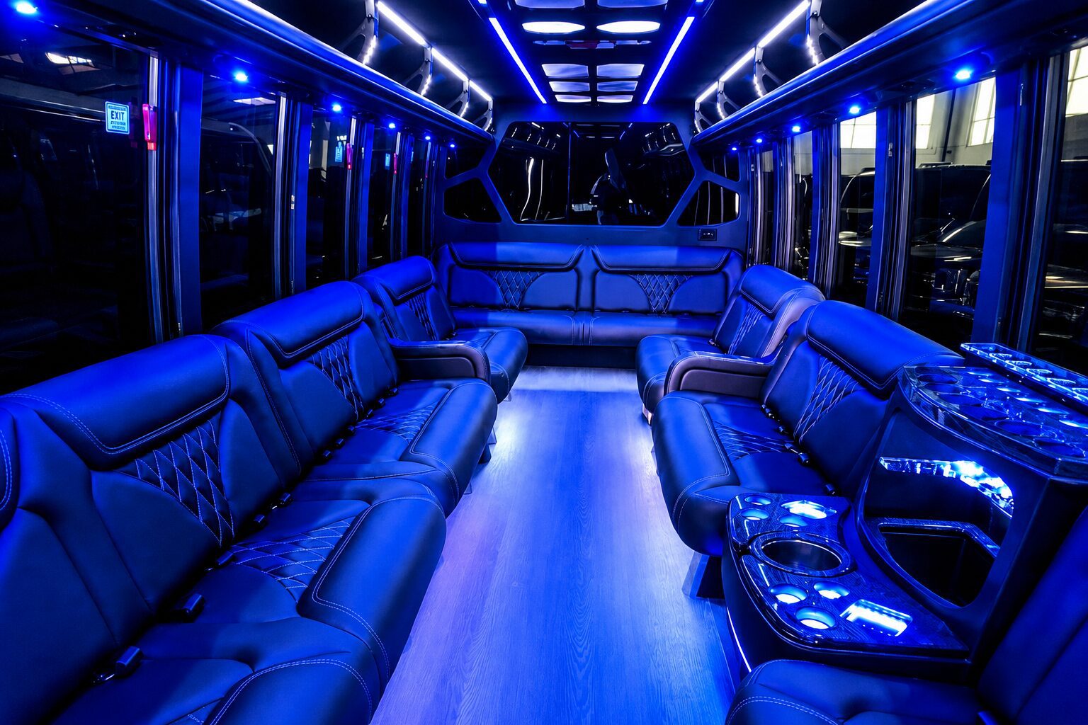 Blue-lit luxury party bus interior with leather seats